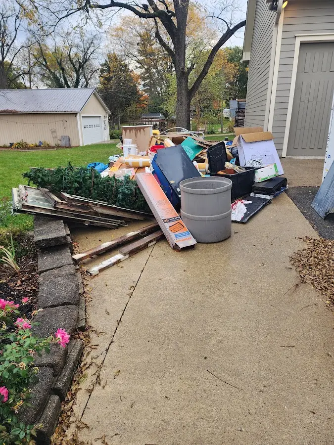 Dumpster being loaded with debris for Estate Cleanout Dumpster Rental in Ross